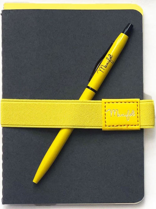 Close up image of twin notebook set in grey and. yellow with matching pen and elastic holder