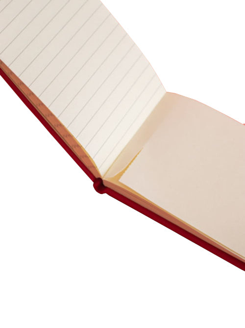 Pocket-sized notebook open to show half plain white pages and half ruled pages inside