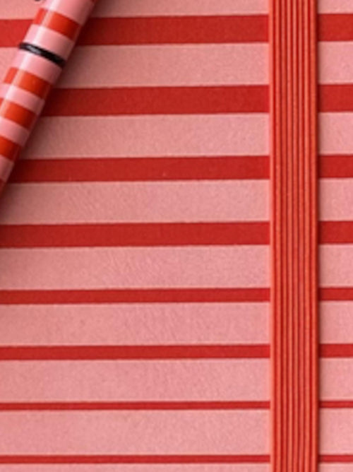 Close-up view of striped A6 notebook cover showing horizontal stripe pattern and textured surface