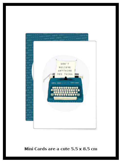 Mini greetings card with old-fashioned typewriter and paper reading "Don't believe anything you think" on white background