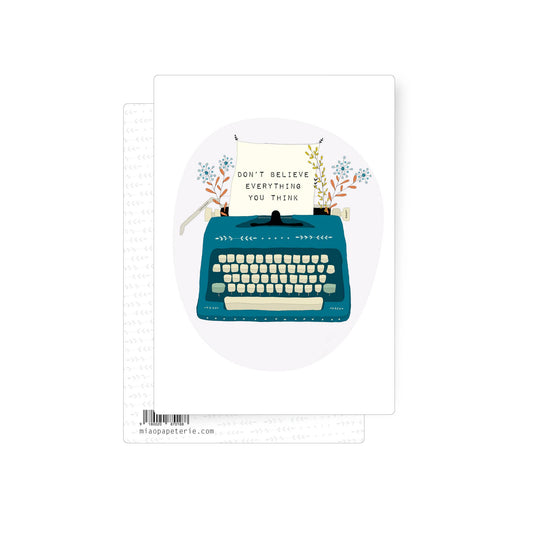 Postcard card with old-fashioned typewriter and paper reading "Don't believe anything you think" on white background