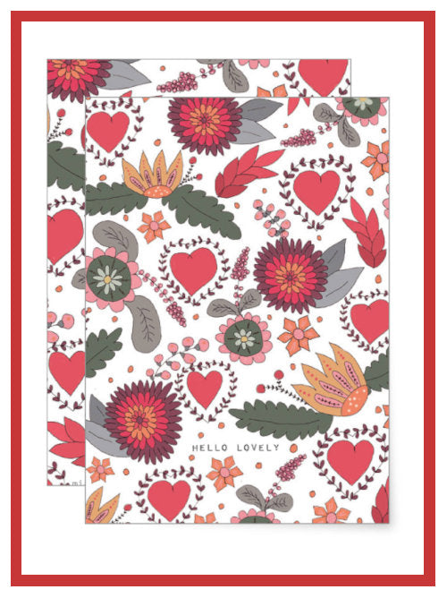 A greetings card covered with a flower motif on a white background and two words at the bottom saying "hello lovely". 
