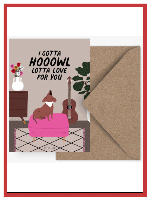 Funny Valentine postcard showing dog howling on pink pouffe with the words “I gotta hooowl lotta love for you”, displayed with Kraft envelope.