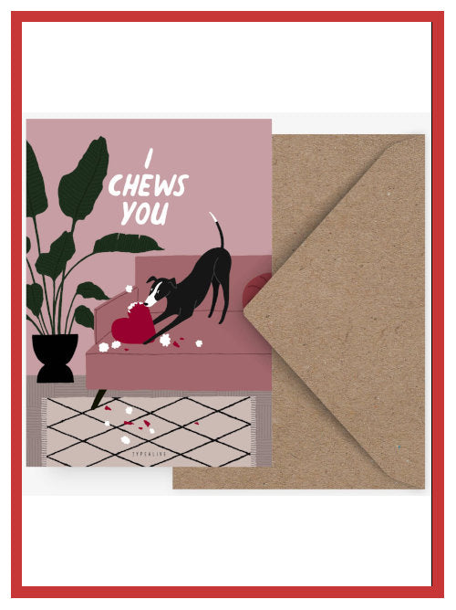 Funny Valentine postcard showing dog chewing heart cushion with the words “I chews you”, displayed with kraft envelope