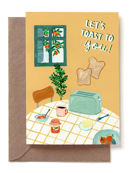 Greeting card with toast and coffee illustration and envelope on a white background with the words "let's toast to you!"