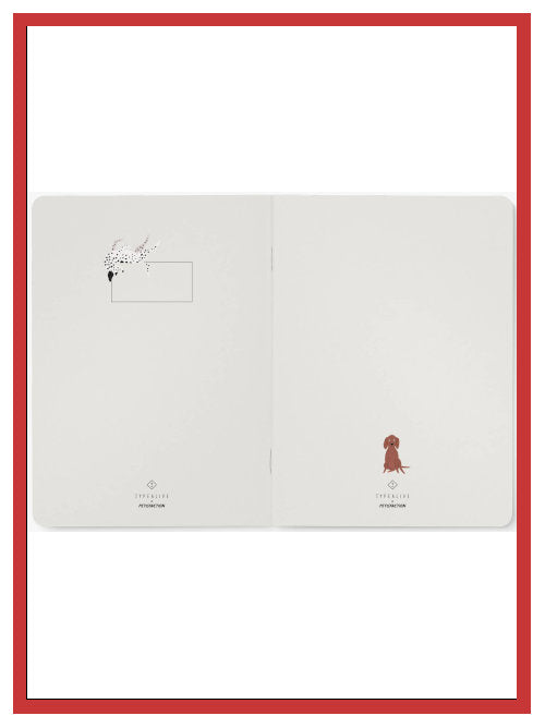 Open A5 notebook showing interior pages with small dog illustrations