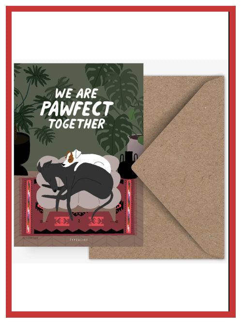 Valentine postcard showing two dogs cuddled together with the words “We are pawfect together”, displayed with kraft envelope