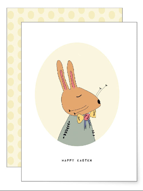 Sweet illustration of a dressed rabbit carrying a bundle of spring flowers over its shoulder, charming woodland Easter greetings card with soft muted colours.