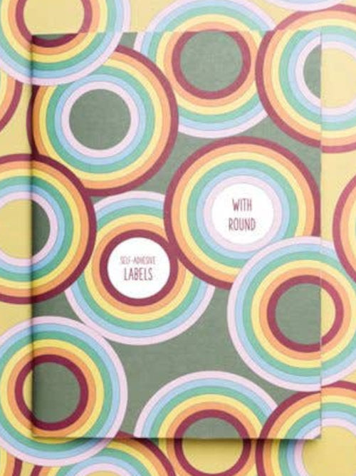 Circular white labels featured on the olive green softcover notebook