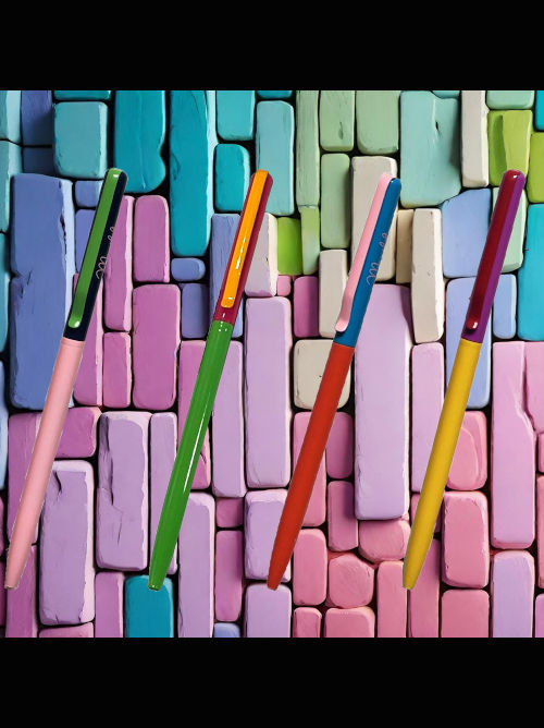Slim colourful metallic pen on a coloured brick background, showing the light pink barrel with dark blue and green colour-block detailing.