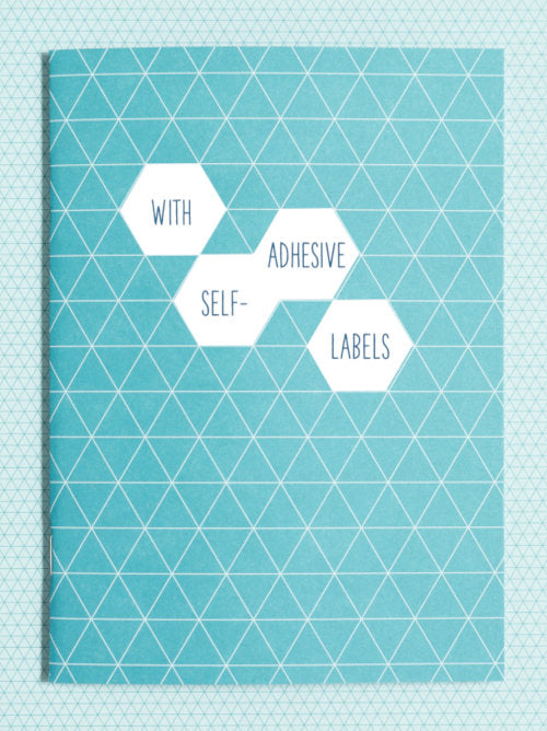 front cover of the turquoise blue notebook with tessellating triangle design. There are also 4 stickers shown that are adhesive labels to be used when desired. Placement is for show only. 