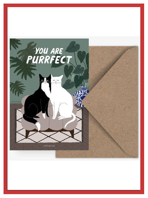 Valentine postcard showing two cats sitting together on sofa with the words “You are purrfect”, displayed with kraft envelope