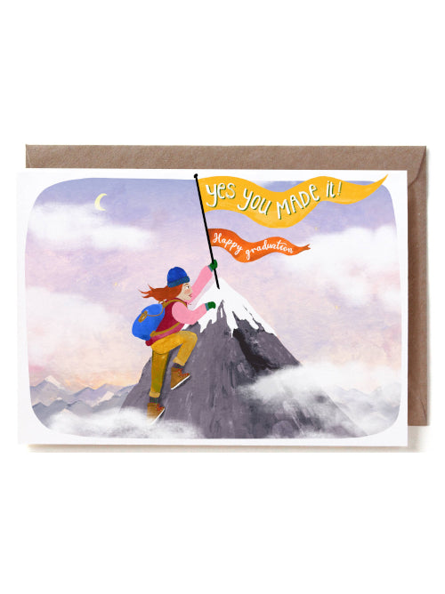 Greeting card with illustration of a climber on a mountain peak, holding a flag with text 'YES YOU MADE IT! Happy graduation!'.
